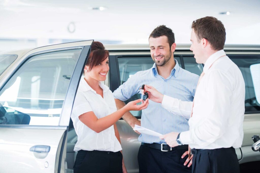 Car buyer receiving new keys, business auto financing, auto broker, car ownership